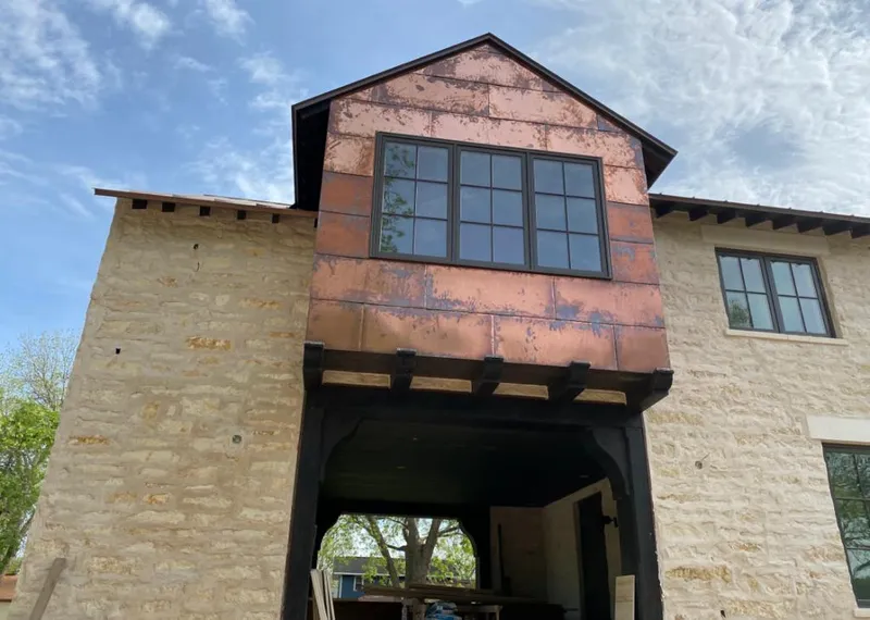 Copper metal panel facade on a stone building for Skylight Installation in Port Sheldon